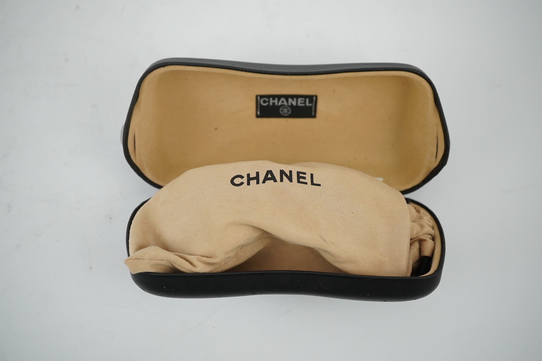 A pair of lady's brown Chanel sunglasses with hard case